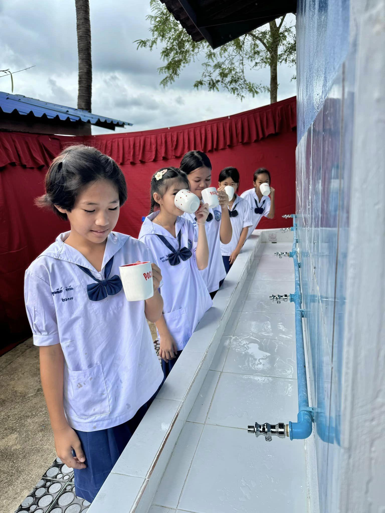 A schoolchild drinking clean, purified water