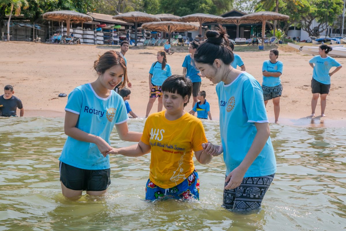 Volunteers and children enjoying a day at the beach